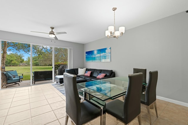 tiled dining room featuring ceiling fan with notable chandelier