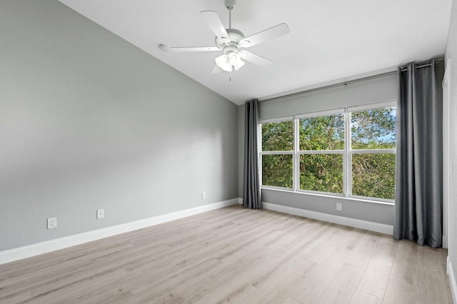 empty room with ceiling fan, lofted ceiling, and light wood-type flooring