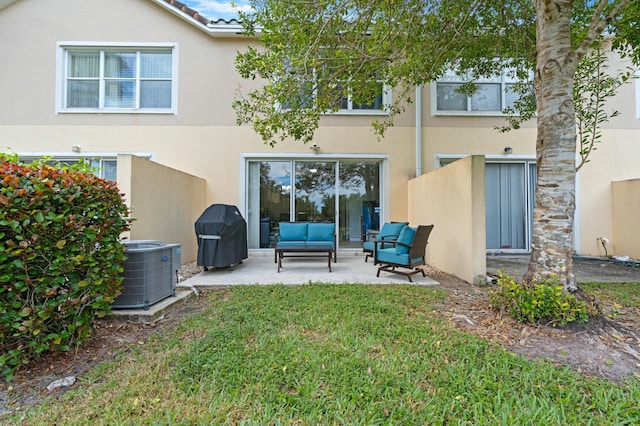 back of property with an outdoor living space, a yard, a patio, and central AC