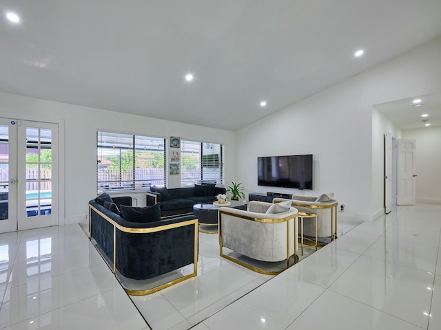 tiled living room featuring french doors and vaulted ceiling