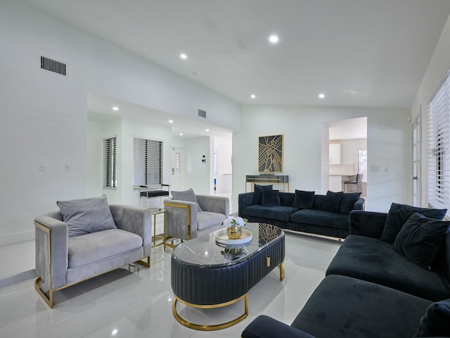 living room with light tile patterned flooring and lofted ceiling