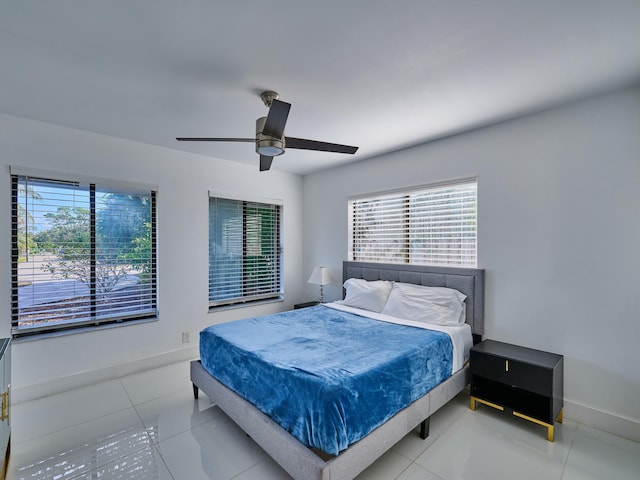 bedroom with ceiling fan and tile patterned flooring