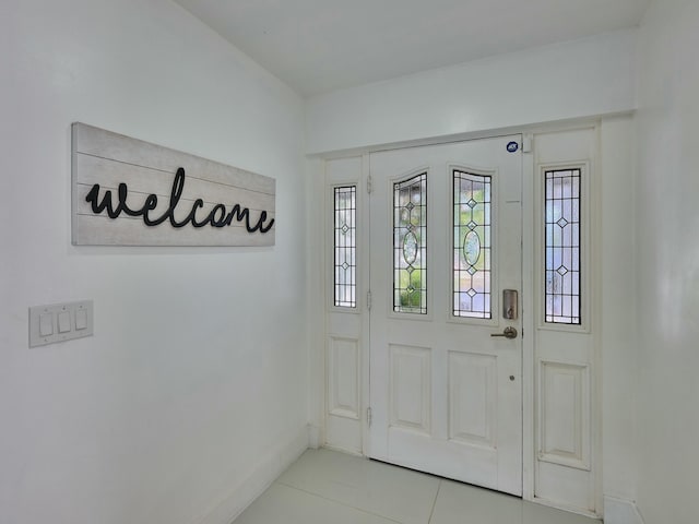 doorway with light tile patterned floors