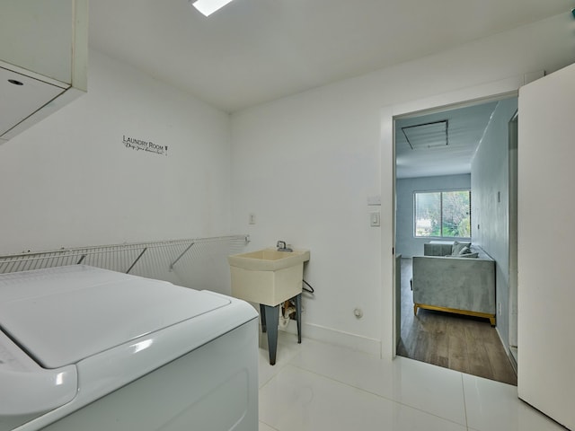 laundry area with light tile patterned flooring and washer / clothes dryer