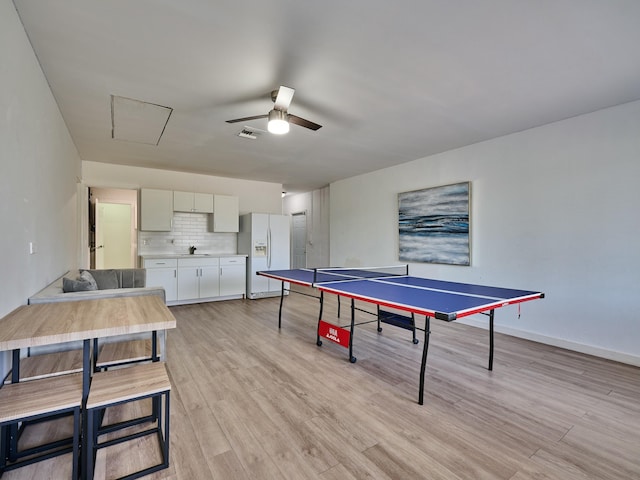 playroom with ceiling fan, sink, and light hardwood / wood-style flooring