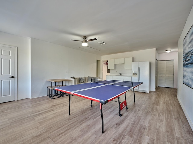 game room featuring ceiling fan, sink, and light hardwood / wood-style floors