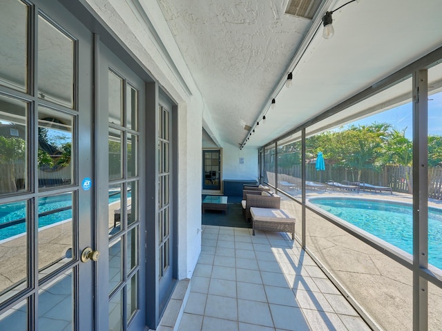 view of swimming pool with a patio and french doors