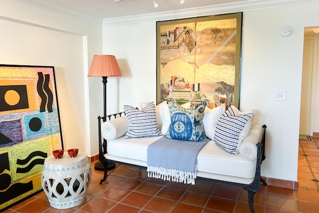 living area featuring tile patterned flooring and crown molding