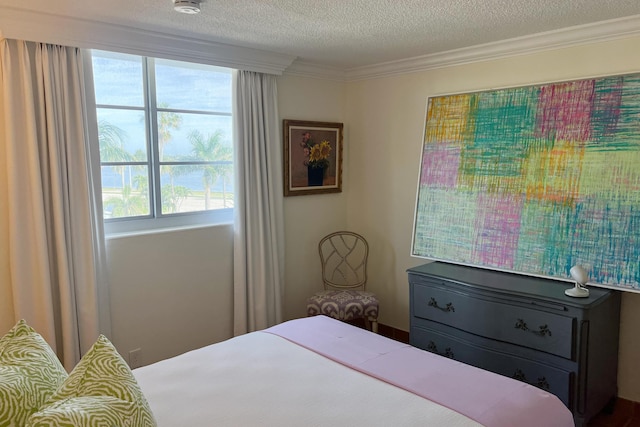 bedroom with multiple windows, a textured ceiling, and ornamental molding