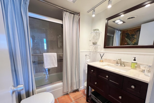 full bathroom with tile patterned flooring, shower / bath combo, toilet, and vanity