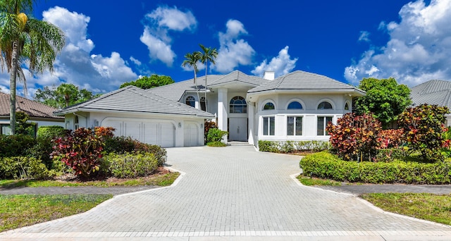 mediterranean / spanish-style home featuring a garage