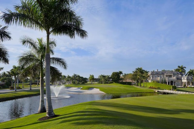 view of home's community with a yard and a water view