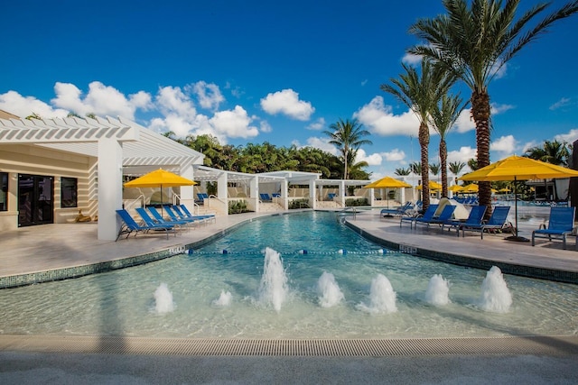 view of swimming pool featuring pool water feature, a pergola, and a patio