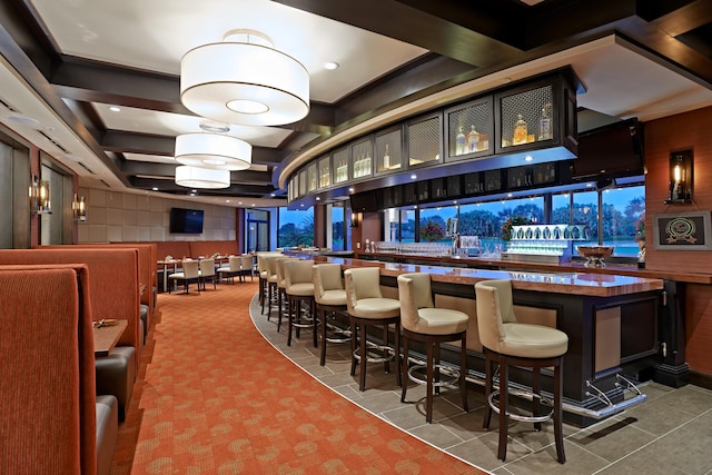 bar with carpet flooring and wood counters