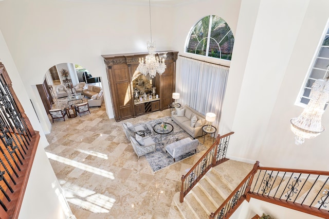 interior space featuring a towering ceiling and a chandelier