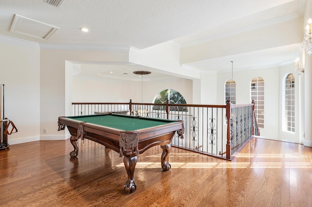 game room featuring billiards, a textured ceiling, hardwood / wood-style floors, and ornamental molding