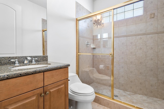 bathroom featuring toilet, an enclosed shower, and vanity