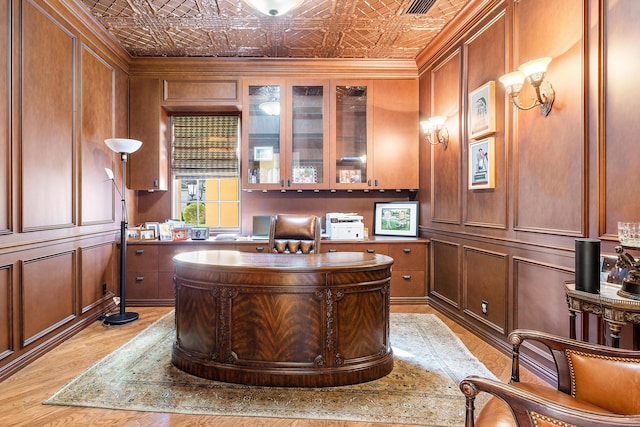 home office featuring wood walls and crown molding