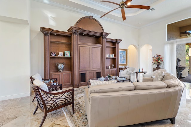 living room featuring ceiling fan, a towering ceiling, and crown molding