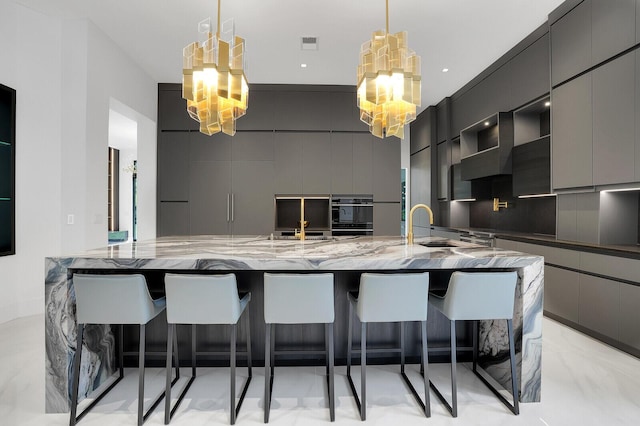 kitchen featuring pendant lighting, gray cabinets, and a breakfast bar