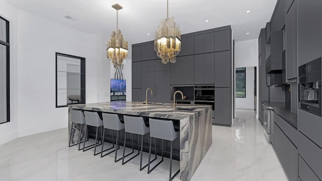 kitchen featuring sink, a large island, pendant lighting, and a kitchen breakfast bar