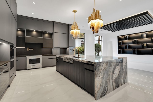 kitchen featuring pendant lighting, a large island, an inviting chandelier, backsplash, and stainless steel range oven