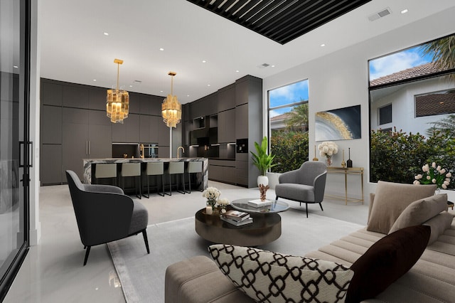 living room featuring a towering ceiling and a chandelier