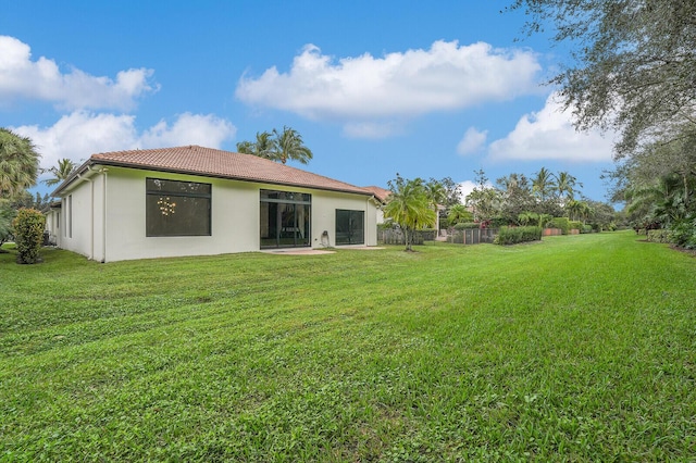 rear view of property with a lawn