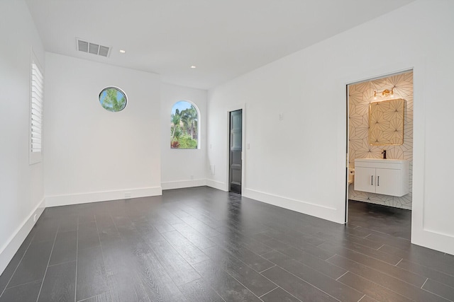 spare room with dark wood-type flooring