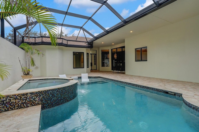 view of swimming pool featuring an in ground hot tub, a lanai, and a patio area