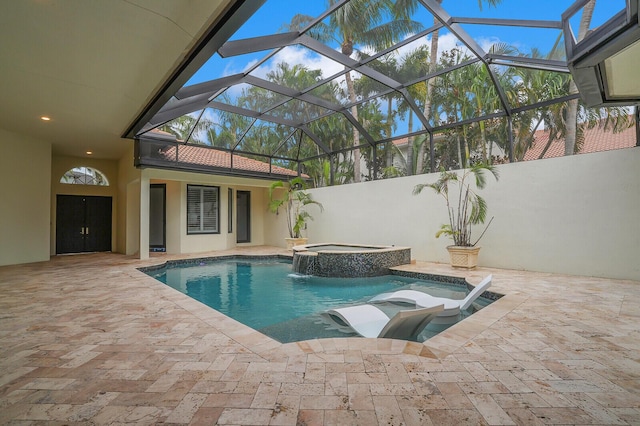 view of swimming pool with an in ground hot tub, a lanai, and a patio