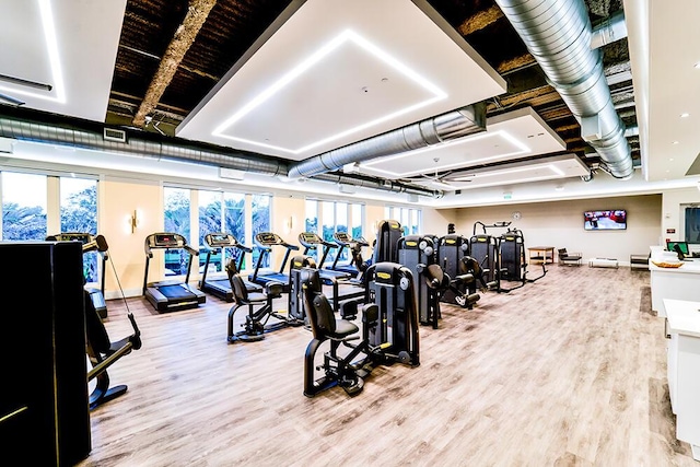 gym with light hardwood / wood-style floors