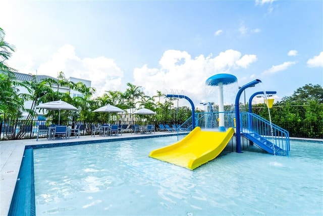 view of pool featuring a playground