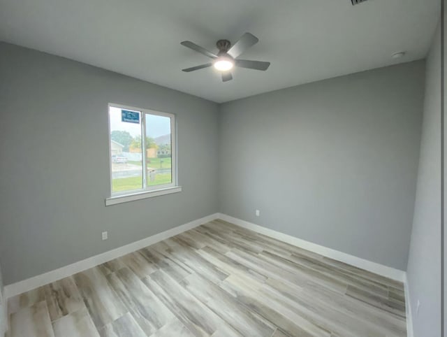 unfurnished room with ceiling fan and light wood-type flooring