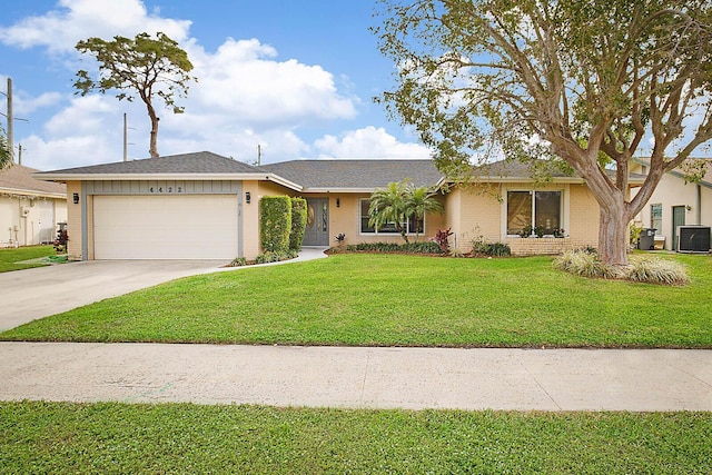 ranch-style home with a garage, central air condition unit, and a front yard