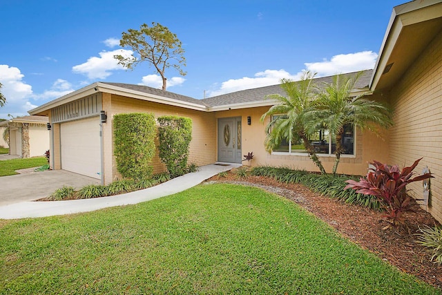 ranch-style home featuring a garage and a front lawn