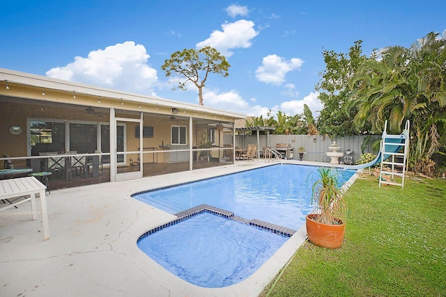 view of swimming pool featuring a patio, a water slide, fence, a sunroom, and a ceiling fan