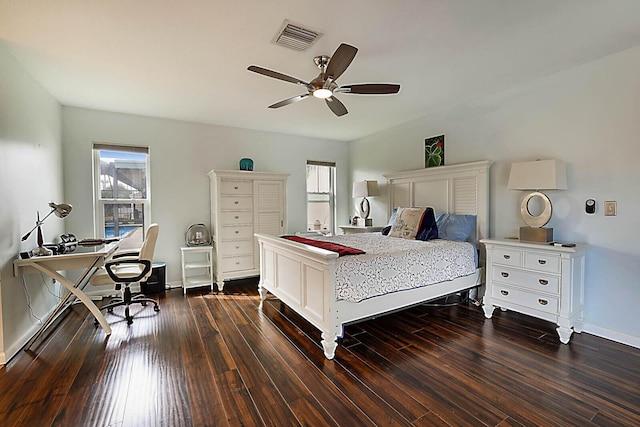 bedroom with a ceiling fan, dark wood-style flooring, visible vents, and baseboards