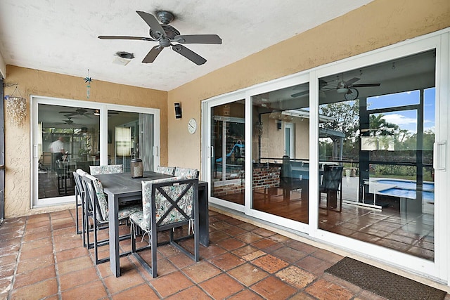 view of patio / terrace featuring a pool, outdoor dining area, and a ceiling fan