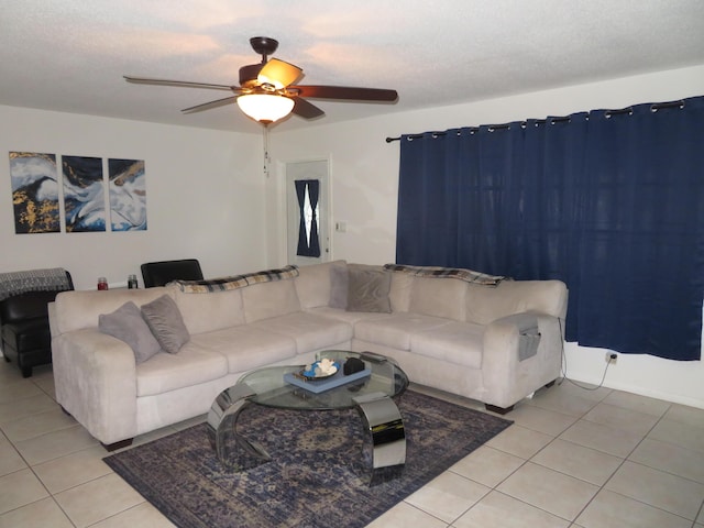 tiled living room featuring ceiling fan and a textured ceiling