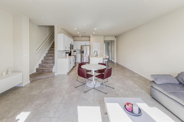 dining room with light tile patterned flooring and sink