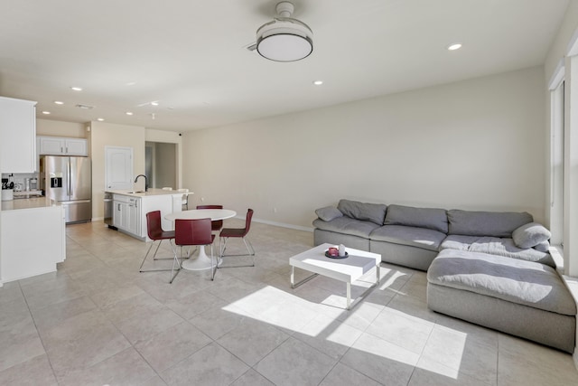 tiled living room featuring sink