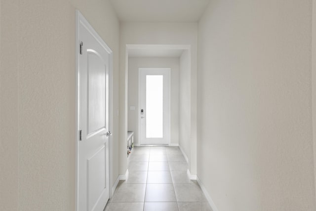 corridor featuring light tile patterned floors