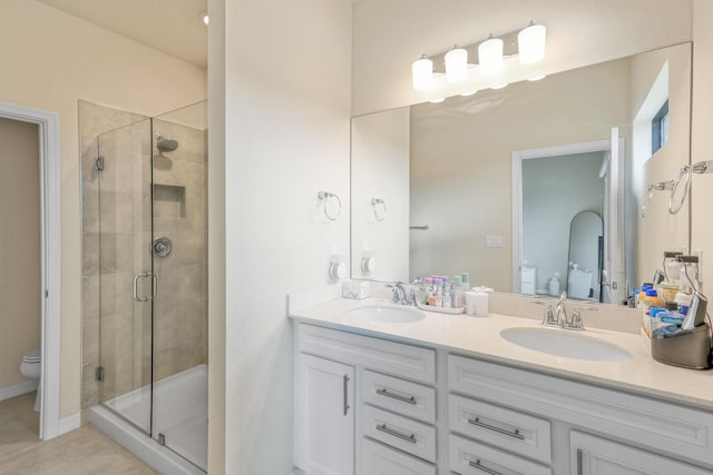 bathroom featuring tile patterned flooring, toilet, an enclosed shower, and vanity