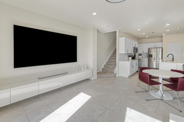 tiled living room featuring sink