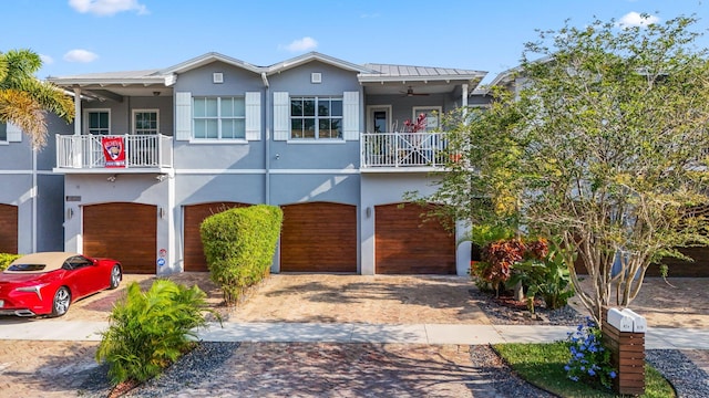 view of front of property with ceiling fan and a garage