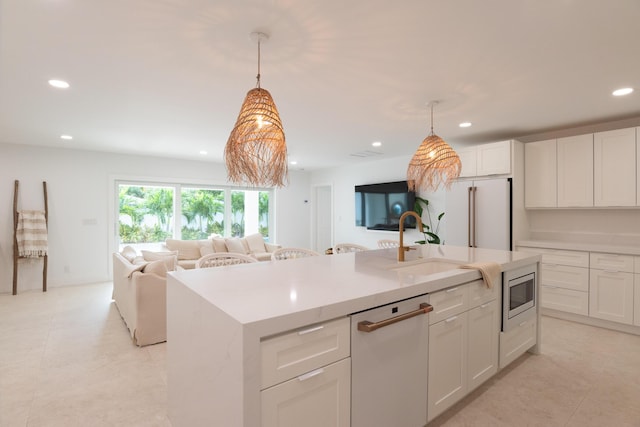 kitchen with dishwasher, a center island with sink, white cabinets, and stainless steel microwave