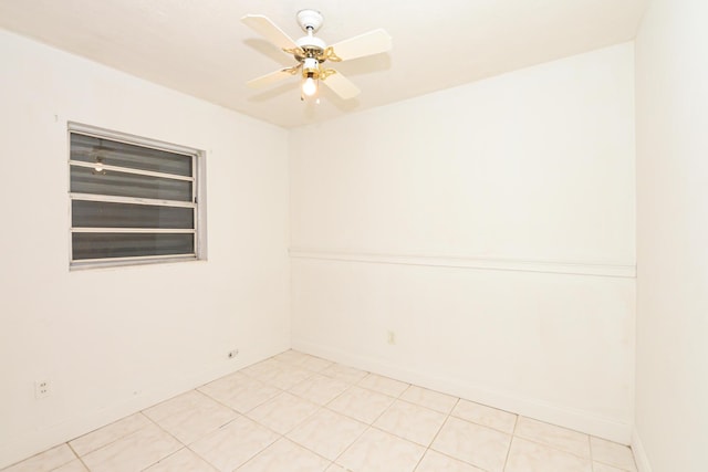 tiled spare room featuring ceiling fan