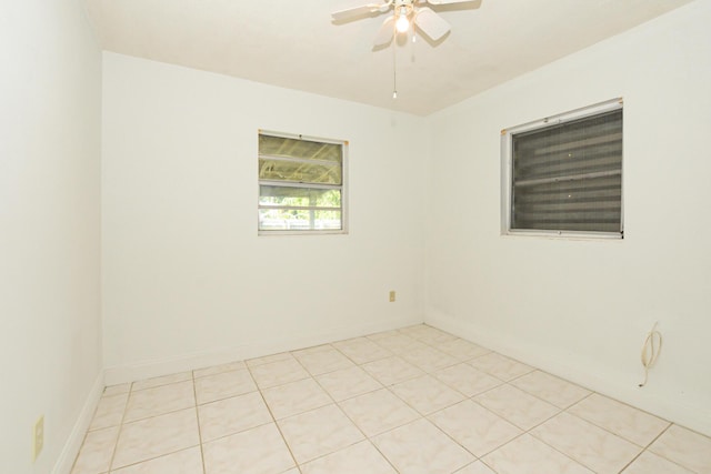 empty room featuring ceiling fan and light tile patterned floors