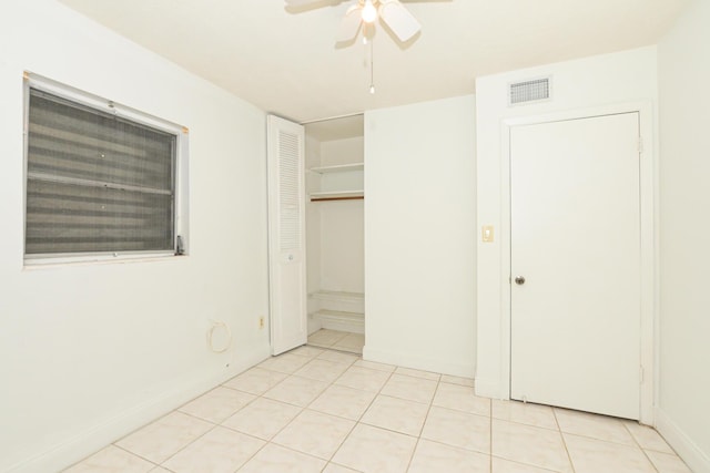 unfurnished bedroom featuring ceiling fan and light tile patterned flooring